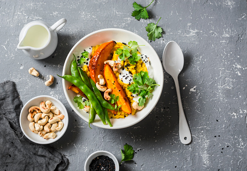 Pumpkin dhal. Traditional indian leguminous vegetables soup. Healthy vegetarian food concept. On a gray background, top view