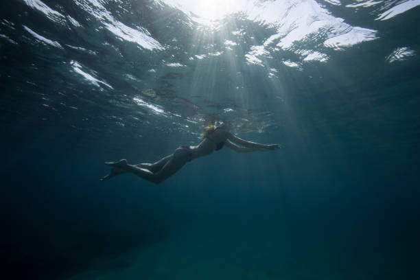 istock Young woman swimming 842390152