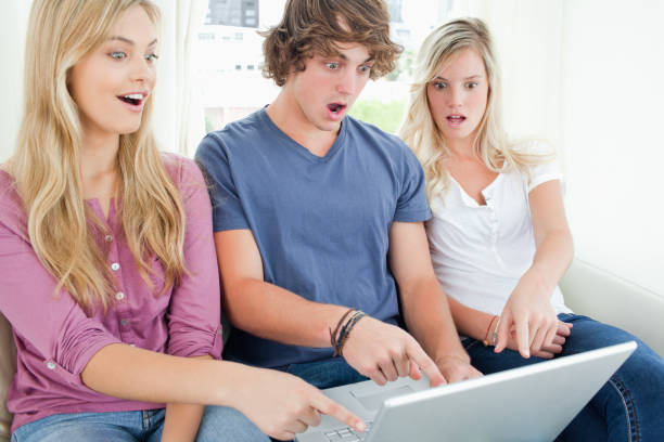 istock three friends shocked at what is on the laptop screen 842393770