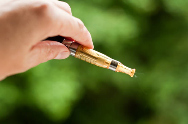 istock e-cigarette with hand closeup in outdoor 842394040