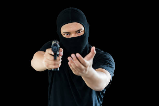 istock terrorist with a gun preparing to fire. isolated black background. with Clipping Path.
