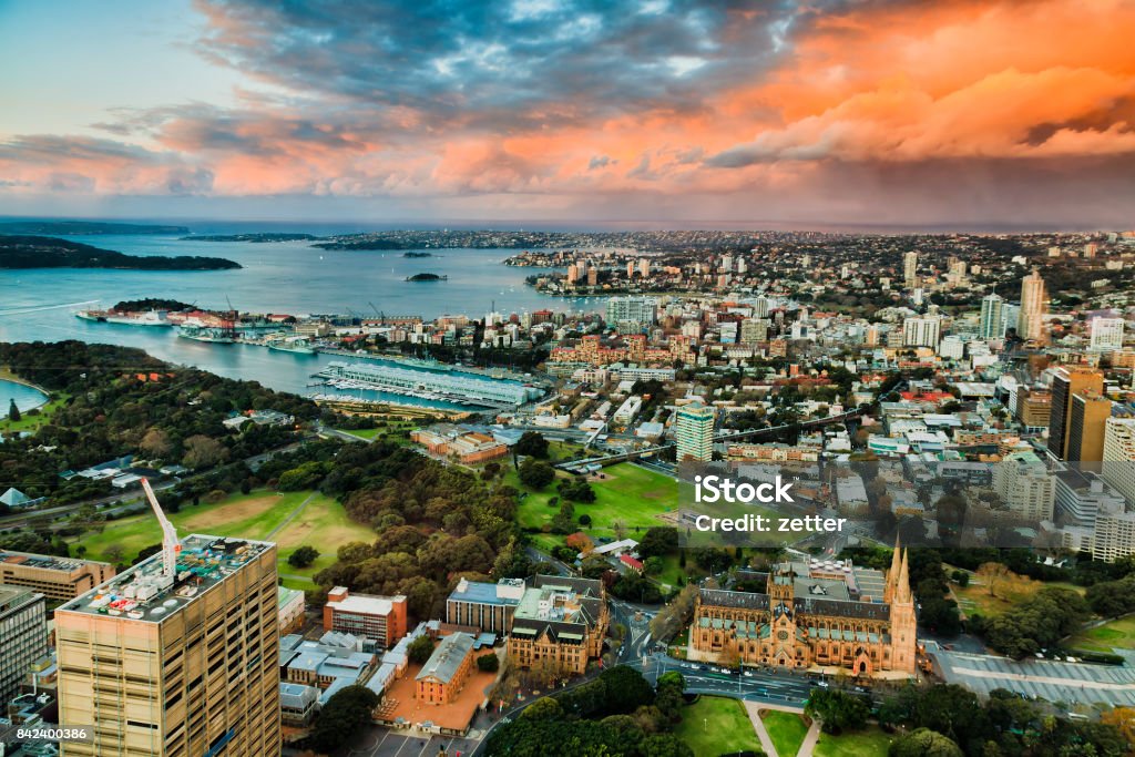 Sy Fr Tower East sunlight Mid-city view above Sydney downtown landmark buildings around Sydney Harbour towards east and Pacific ocean at sunset. Sydney Stock Photo