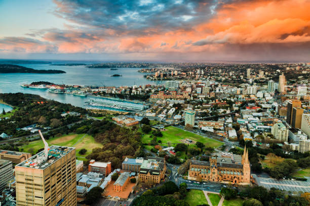 Sy Fr Tower East sunlight Mid-city view above Sydney downtown landmark buildings around Sydney Harbour towards east and Pacific ocean at sunset. hyde park sydney stock pictures, royalty-free photos & images