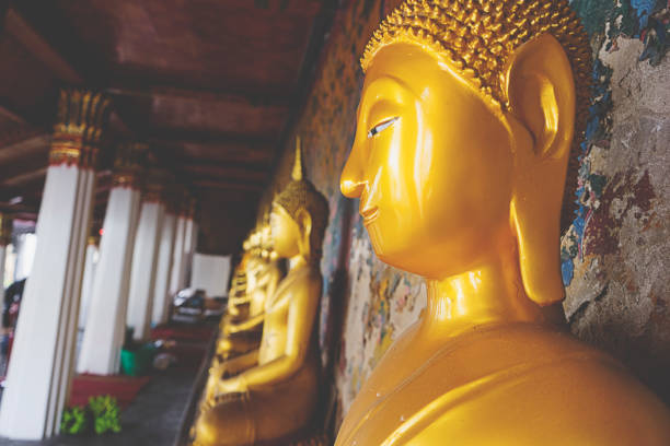 Golden Buddha statue in Wat Arun or Temple of Dawn in Bangkok, Thailand