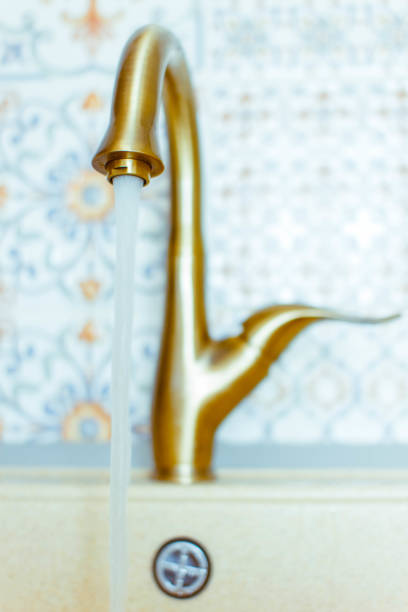 istock Golden faucet with sink 842412280