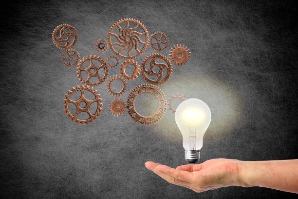 istock Light bulb in mid-air on the hand with the gears against abstract background 842418732
