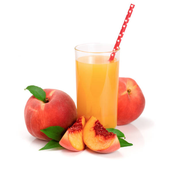istock Glass of fruit juice with straw and cut peaches isolated on white background 842425392