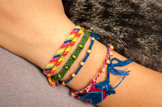 A colorful friendship bracelet on a child's hand Closeup of a colorful friendship bracelet on a child's hand holding a cat friendship bracelets hands stock pictures, royalty-free photos & images