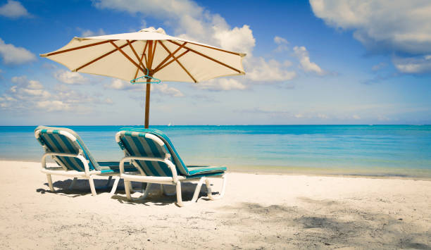 istock Sunny beach with two sunbeds and parasol 842432616