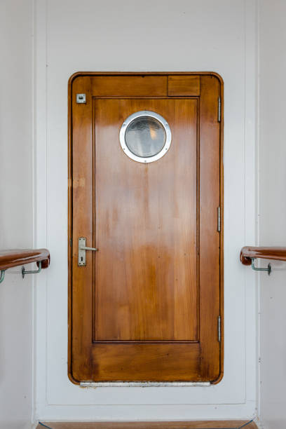 Vintage wooden narrow door on old ship stock photo