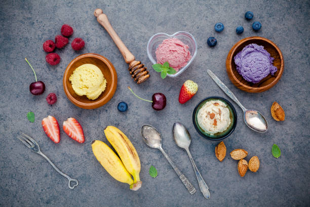 istock Flat lay ice cream with various fruits raspberry ,blueberry ,strawberry ,banana and cherry  setup on dark stone background . Summer and Sweet menu concept. 842434730