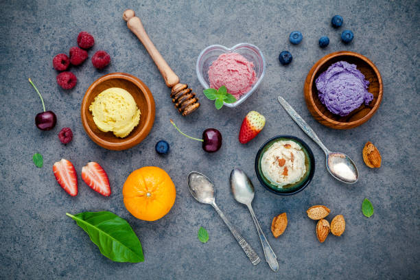 istock Flat lay ice cream with various fruits raspberry ,blueberry ,strawberry ,orange and cherry  setup on dark stone background . Summer and Sweet menu concept. 842434950