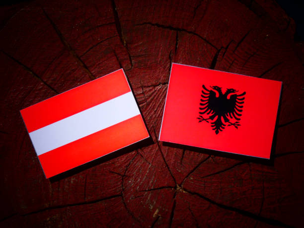 istock Austrian flag with Albanian flag on a tree stump isolated 842436314