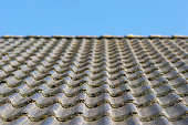 Roof hung with gray concrete roof tiles