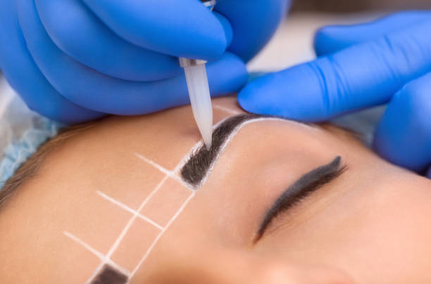 istock Permanent make-up for eyebrows of beautiful woman with thick brows in beauty salon. 842438558