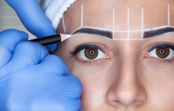 istock Permanent make-up for eyebrows of beautiful woman with thick brows in beauty salon. 842438566