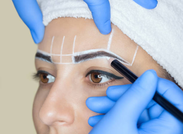 istock Permanent make-up for eyebrows of beautiful woman with thick brows in beauty salon. 842438578
