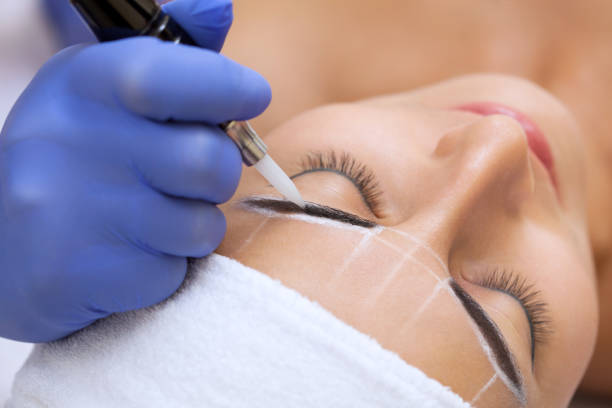 istock Permanent make-up for eyebrows of beautiful woman with thick brows in beauty salon. 842438588