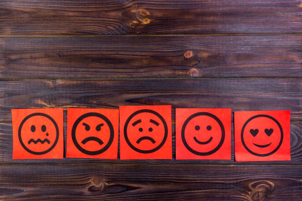 istock Red paper notes with happy, joy, anger, laughter and sad faces on blackboard. Vignette. 842440412