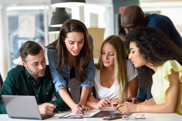 istock Multi-ethnic group of young men and women studying indoors. 842440646