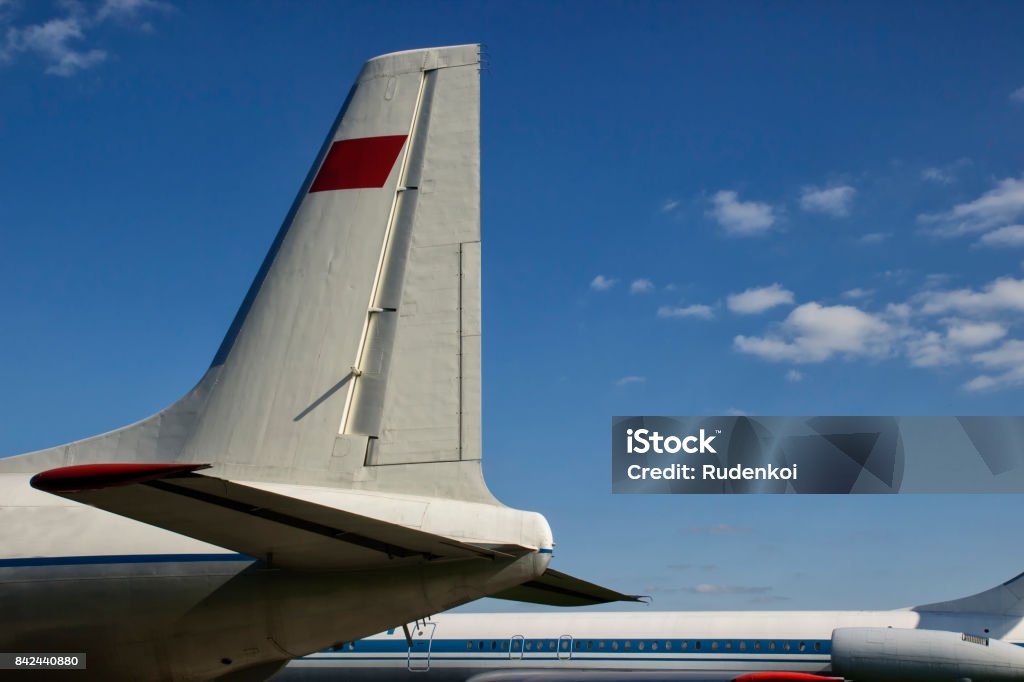 Tail of an airplane, airport Tail of an airplane, airport, sunny day,sky, slouds Airplane Tail Stock Photo