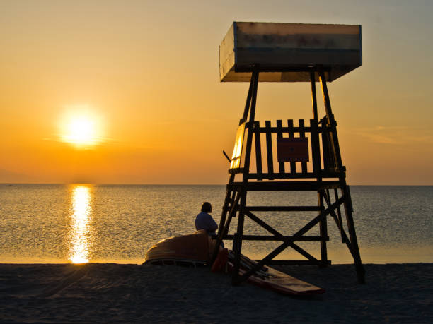 istock Lifeguard watchtower at summer sunset on a beach 842442180
