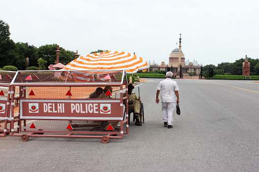 New Delhi, India: A man walks through police barricades to Rashtrapati Bhavan (president house) in New Delhi, India.