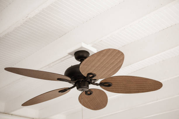 Low Angle View of a rustic ceiling fan in an old house Low Angle View of a rustic ceiling fan in an old house ceiling fan stock pictures, royalty-free photos & images