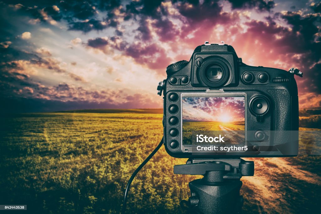 Digital camera concept. photography view camera photographer lens lense video photo digital glass blurred focus landscape photographic color concept sunset sunrise sun light sky cloud - stock image Making Stock Photo