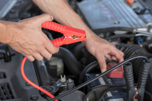 istock Charging car battery from another car with a set of jumper cables 842444100