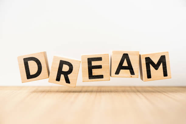 istock Surreal abstract geometric floating wooden cube with word DREAM concept 842446716