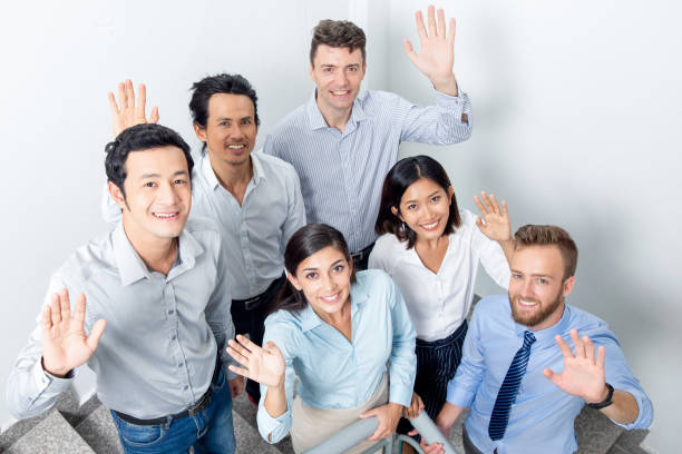 istock Friendly Business Team Waving on Office Stairway 842447002
