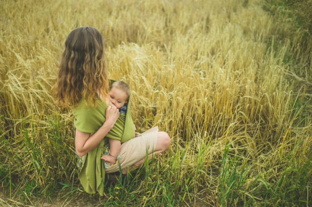 istock Mother breastfeeding baby in field 842448716
