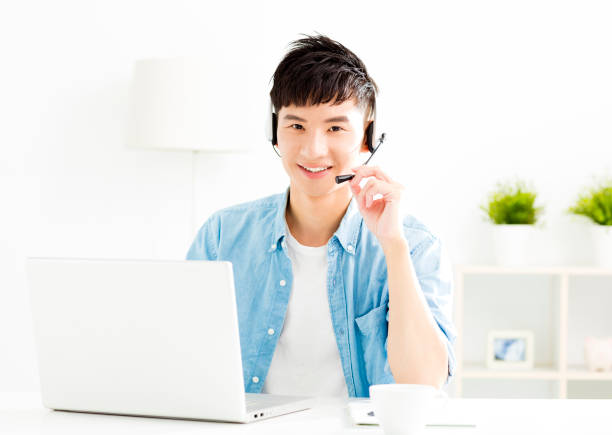 istock Happy young man with headset and laptop 842449650