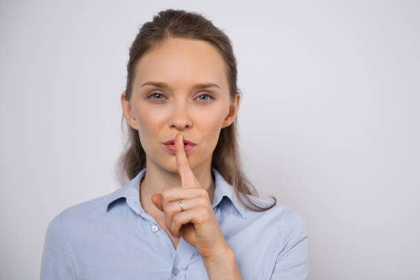 istock Enigmatic woman showing shh gesture 842449784