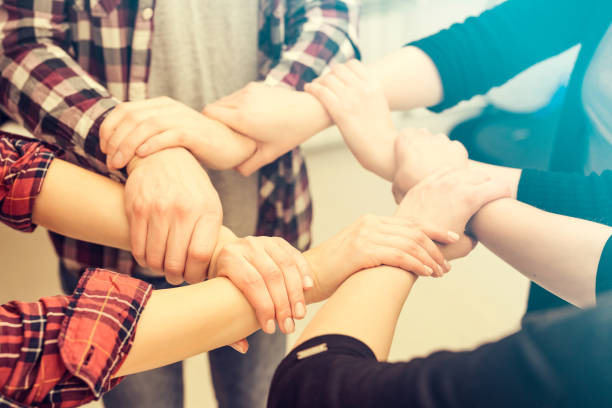 istock A group of young people hold strong hands. 842450214