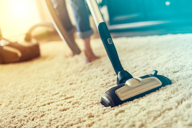 istock Woman using a vacuum cleaner while cleaning carpet in the house. 842451024