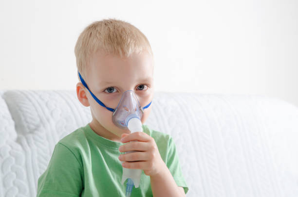 istock Boy making inhalation with nebulizer at home 842452260