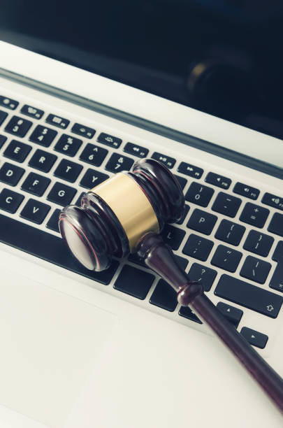 istock Wooden gavel on laptop keyboard 842452602