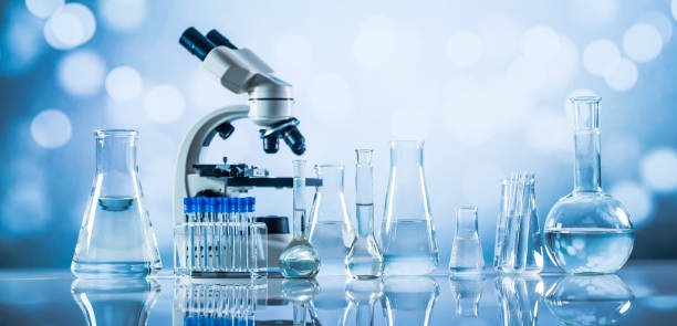 Science laboratory research and development concept. microscope with test tubes stock photo