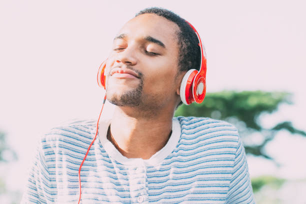 istock Relaxed young man loving music enjoying nature 842454774
