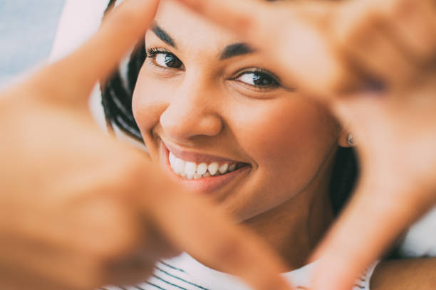istock Smiling young woman making frame with fingers 842456108