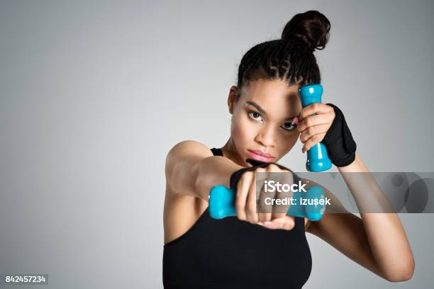 Afro American Fit Young Woman In Sports Wear Holding Dumbbell Weights Stock Photo - Download Image Now