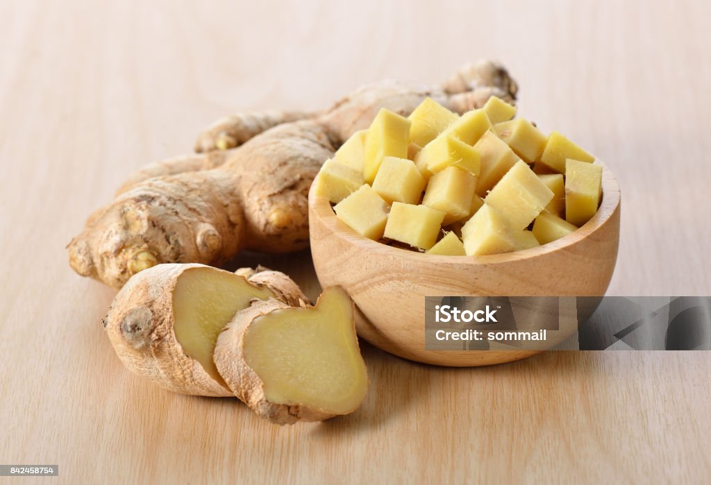 ginger sliced in wood bowl Ginger - Spice Stock Photo