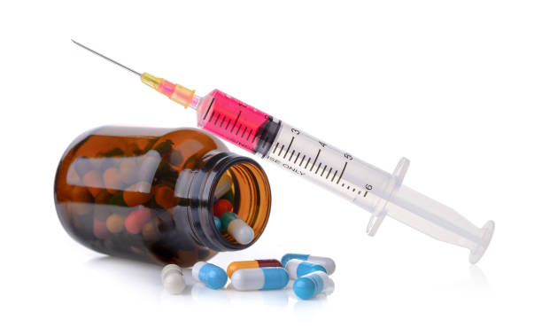 istock pill and bottle and  plastic syringe isolated on white background 842458766