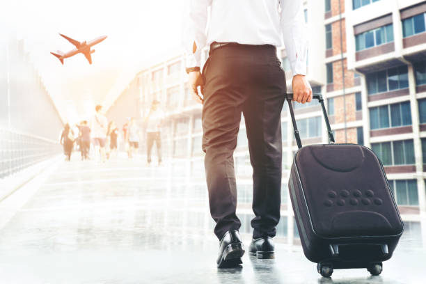 istock Businessman holding trolley bag going up on travel 842459408