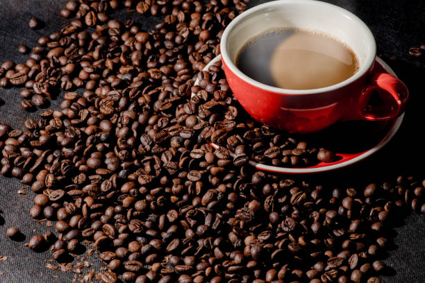 istock Hot coffee in red cup and coffee beans are the background. 842462232
