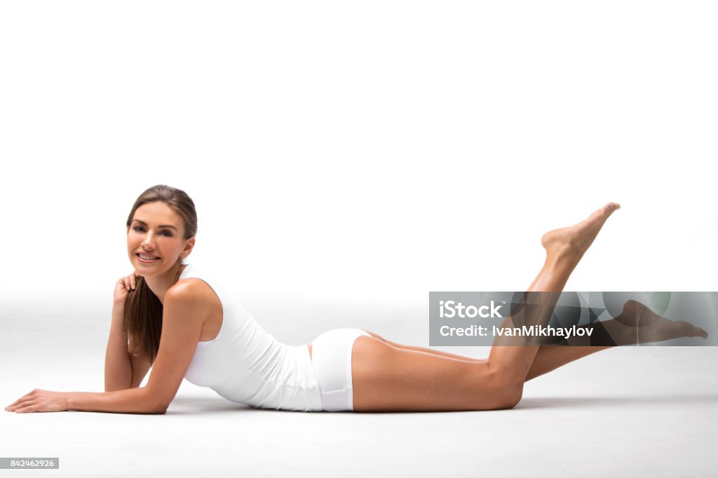 Beautiful woman in underwear Young beautiful woman in cotton underwear sitting on white background Slim Stock Photo