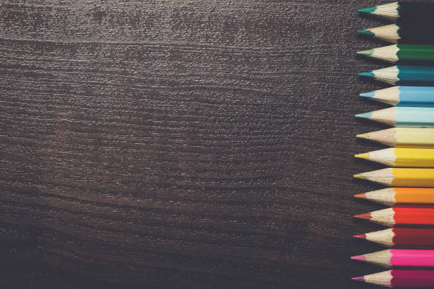 istock colorful pencils on dark brown table background 842464062