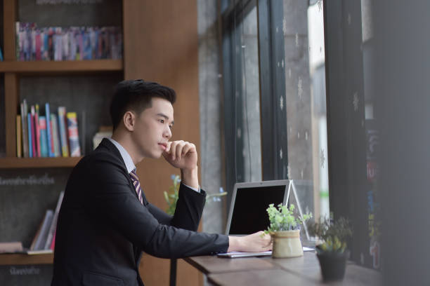 istock Young attractive Asian business man sleeping, drowsing or taking a nap at her desk, Tired business man accountant with bills and paper folders in office, tired young business woman with laptop. 842464292